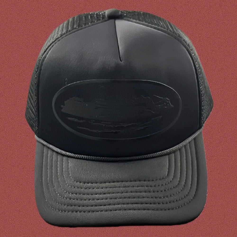 Cortiez All-Black Monochromatic Oval Ship Logo Trucker Hat